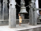 Nepal, Central Region, Bagmati Zone, Pharping, Bungamati: A kid rings the bell at the Rato Machhindranath temple