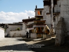 Tibet, Shigatse, Tashilhunpo monastery: A monk turning prayerwheels near the museum, close to the eastern wall of the compound