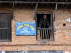 Nepal, Central Region, Bagmati Zone, Pharping: Old man in a window.
