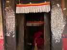 Tibet, Shiga Tse, Zhashen Lumbu monastery (Tashi Lhunpo): The door from near the tunnel up to the tomb of the 4th Panchen Lama covered with coins from pilgrims
