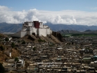 Tibet, Shigatse, Tashilhunpo Kora: The dzong as seen from the kora at the thangka wall