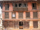 Nepal, Central Region, Bagmati Zone, Bhaktapur, Tibuche Tole: Woodcarved windows of a tradtional brick houses