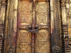 Nepal, Central Region, Bagmati Zone, Bhaktapur District: Changu Narayan Temple; Door covered with brass and two Talsa at the western side of the Narayan-Temple, opposite the Vishnu-Garuda temple, see also photos L1040511 to L1040 517
